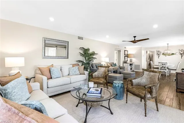 a living room with furniture and a large mirror