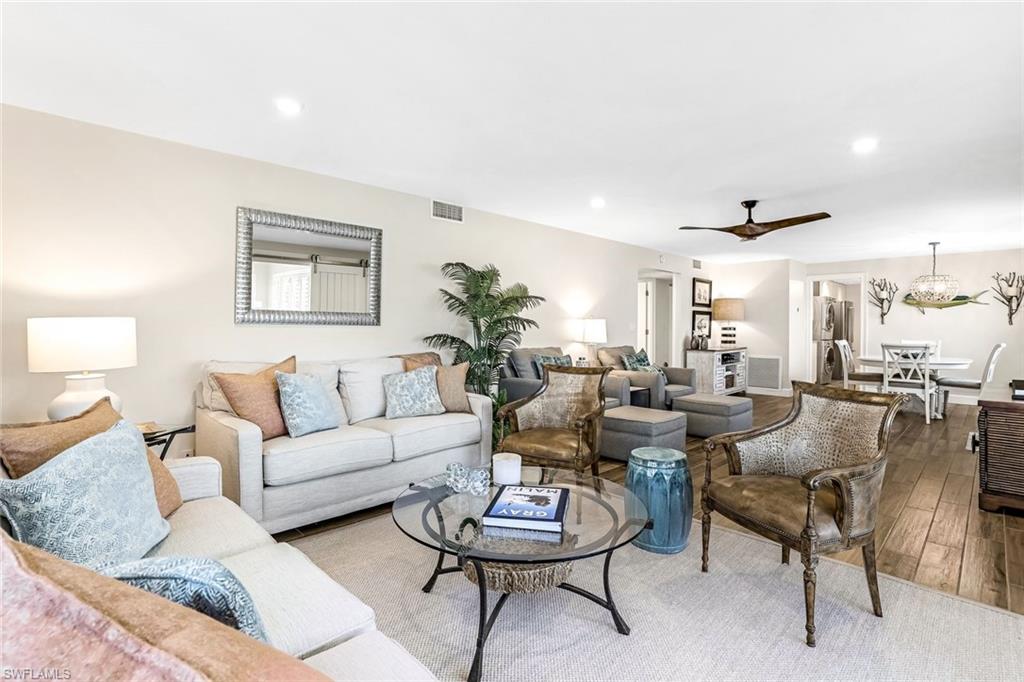 1100 8th Avenue South, Unit H227 Naples, FL 34102 - Photo 5 of 22 a living room with furniture and a large mirror