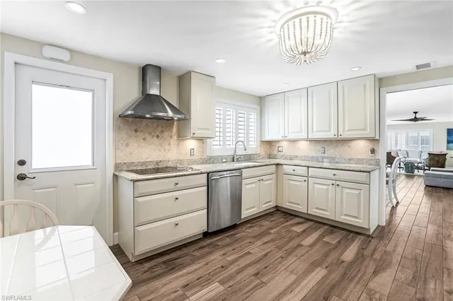 a kitchen with a sink a window and stainless steel appliances