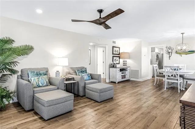 a living room with furniture and a kitchen view