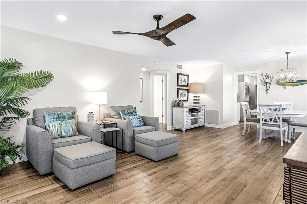 1100 8th Avenue South, Unit H227 Naples, FL 34102 - Photo 10 of 22 a living room with furniture and a kitchen view