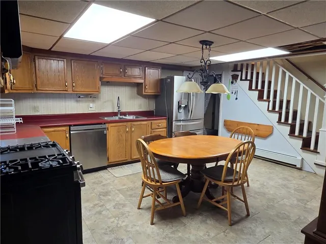 a dining room filled chandelier and wooden floor