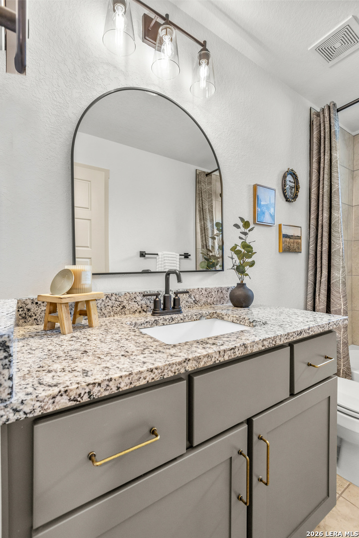 116 Hiram Cook Blanco, TX 78606 - Photo 28 of 53 a bathroom with a granite countertop sink and a mirror