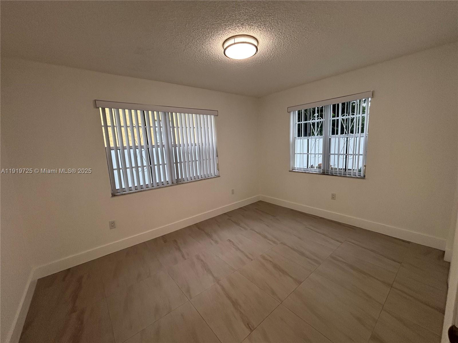 3616 Southwest 17th Street, Unit 3616 Miami, FL 33145 - Photo 4 of 16 an empty room with windows