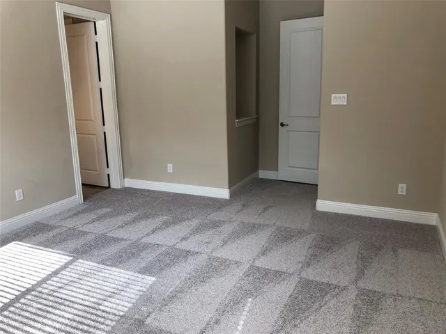 a view of wooden floor and a window in a room