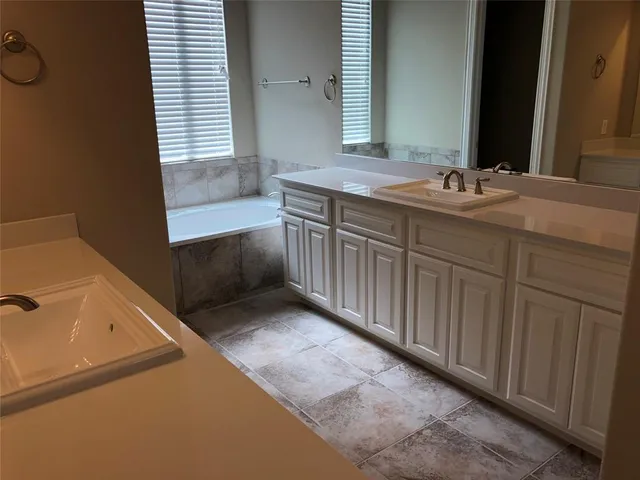 a bathroom with a bathtub and a window