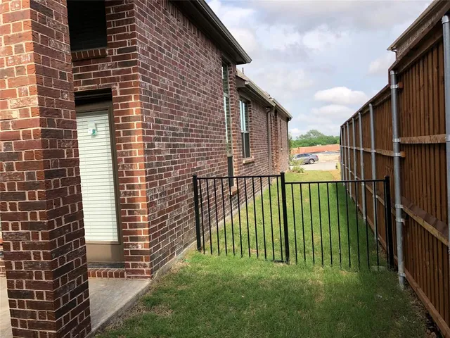 a view of backyard of house with green space