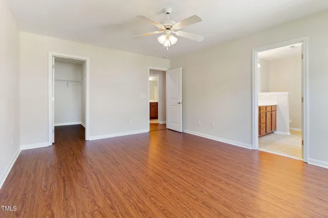 a view of a room with wooden floor