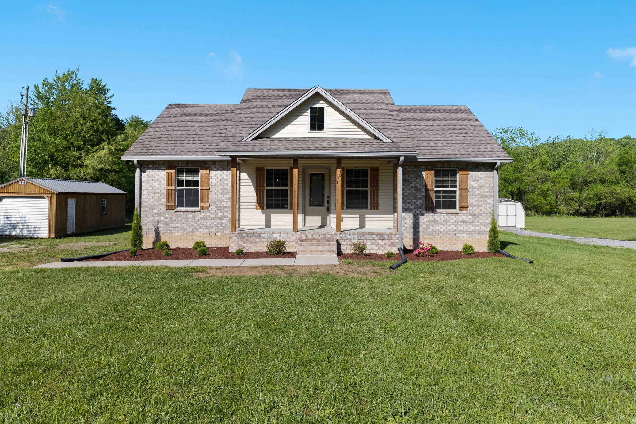 1821 Rock Bridge Road Bethpage, TN 37022 - Photo 1 of 31 a front view of a house with a yard and trees