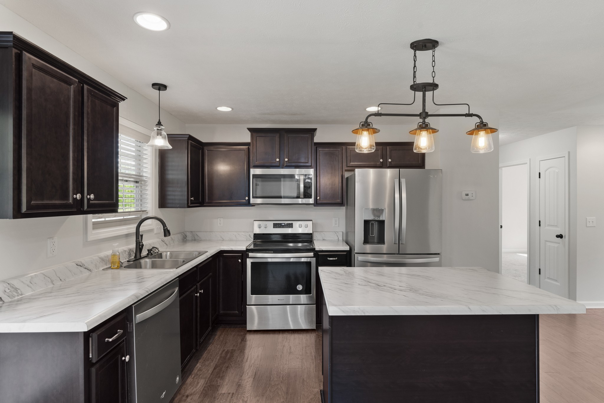 1821 Rock Bridge Road Bethpage, TN 37022 - Photo 11 of 31 a kitchen with stainless steel appliances a sink stove and refrigerator