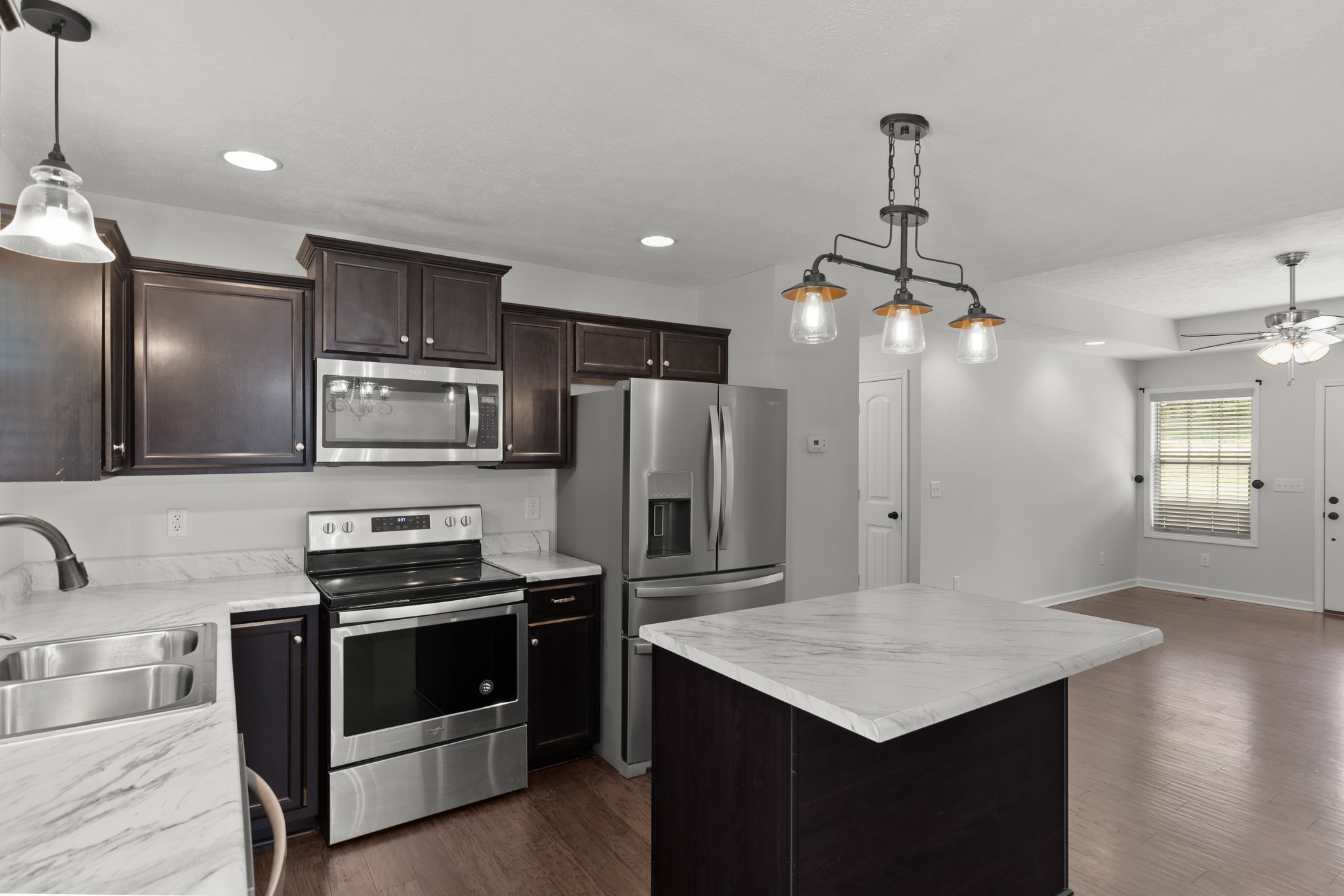 1821 Rock Bridge Road Bethpage, TN 37022 - Photo 12 of 31 a kitchen with stainless steel appliances kitchen island a cabinets and wooden floor