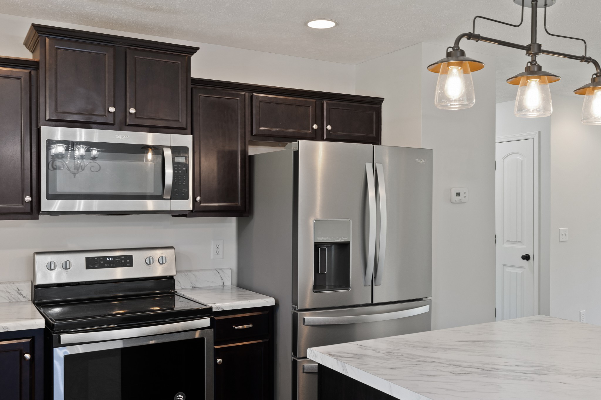 1821 Rock Bridge Road Bethpage, TN 37022 - Photo 13 of 31 a kitchen with granite countertop a refrigerator stove and microwave