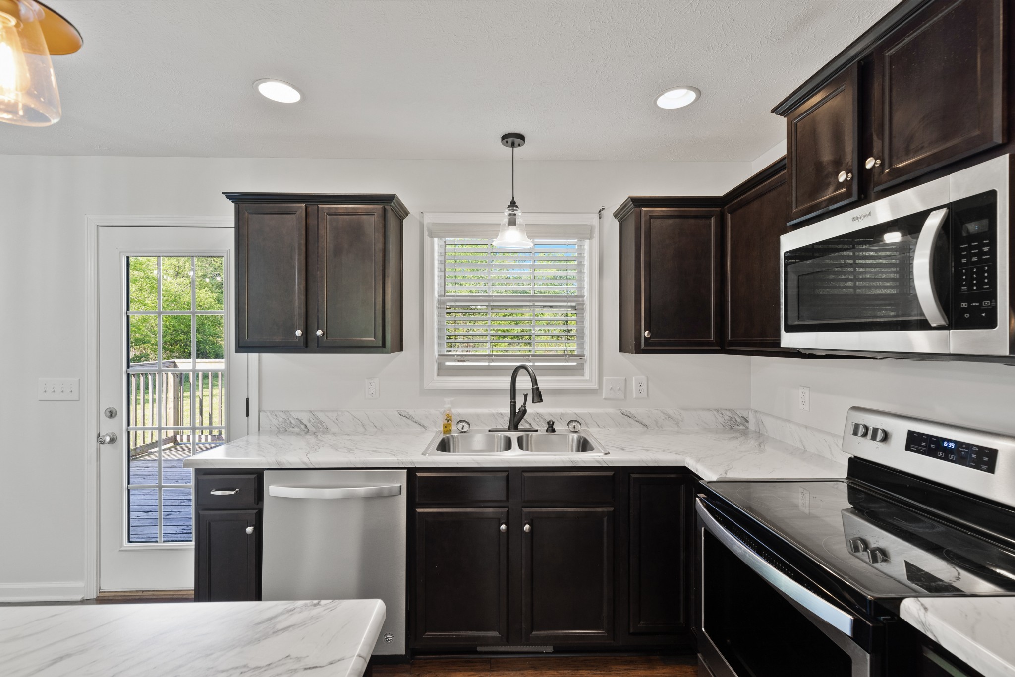 1821 Rock Bridge Road Bethpage, TN 37022 - Photo 14 of 31 a kitchen with stainless steel appliances a sink microwave and stove