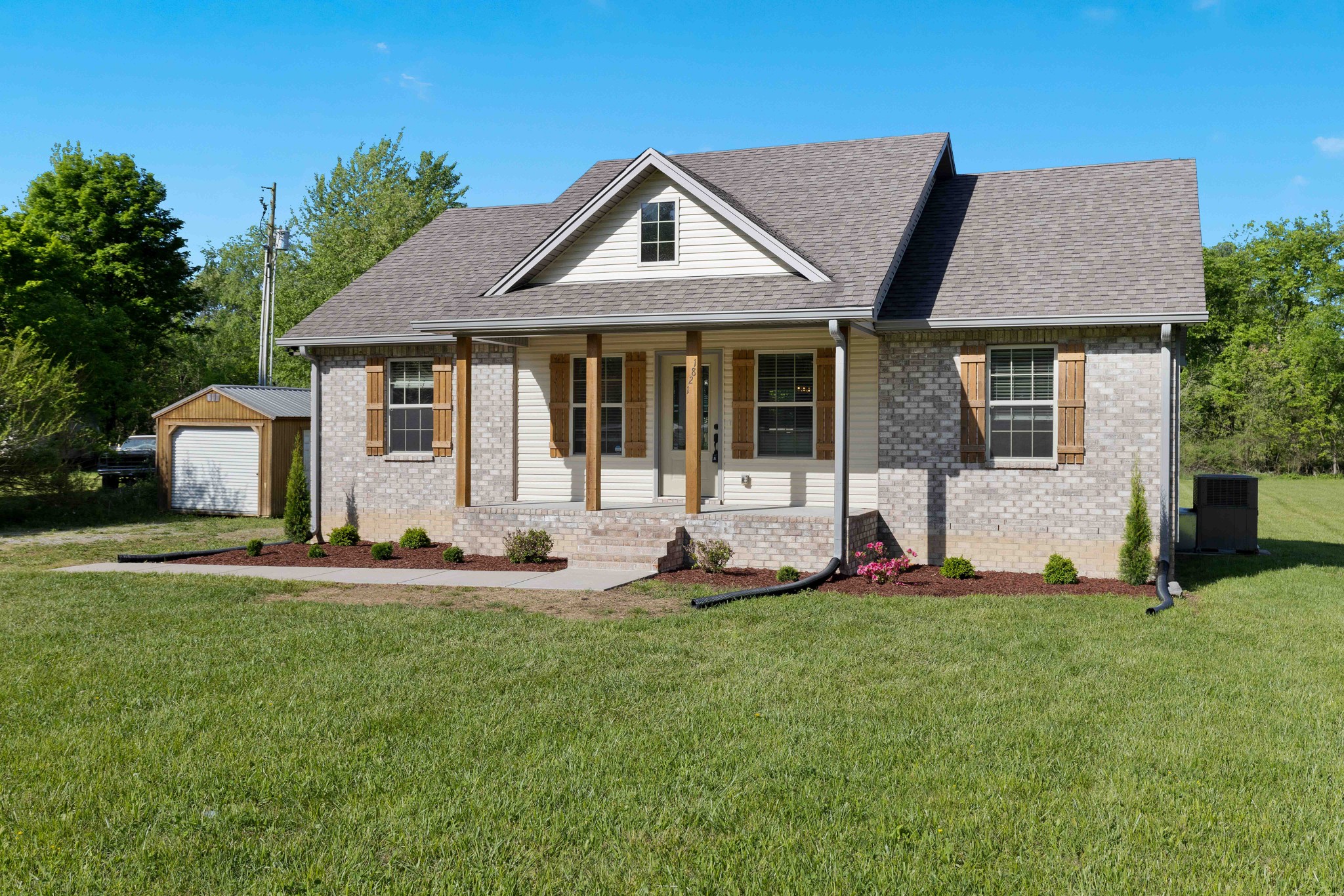 1821 Rock Bridge Road Bethpage, TN 37022 - Photo 2 of 31 a front view of a house with a yard and sitting area