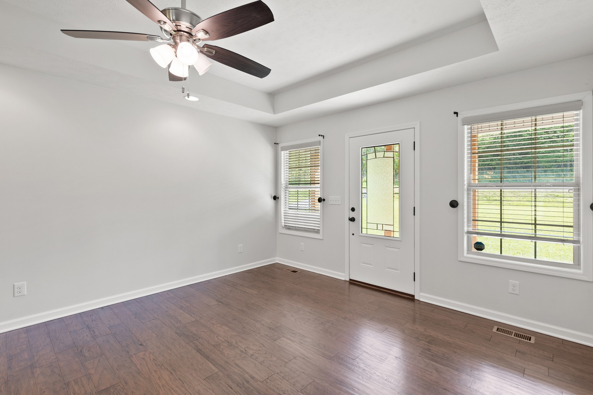 1821 Rock Bridge Road Bethpage, TN 37022 - Photo 8 of 31 an empty room with wooden floor fan and windows