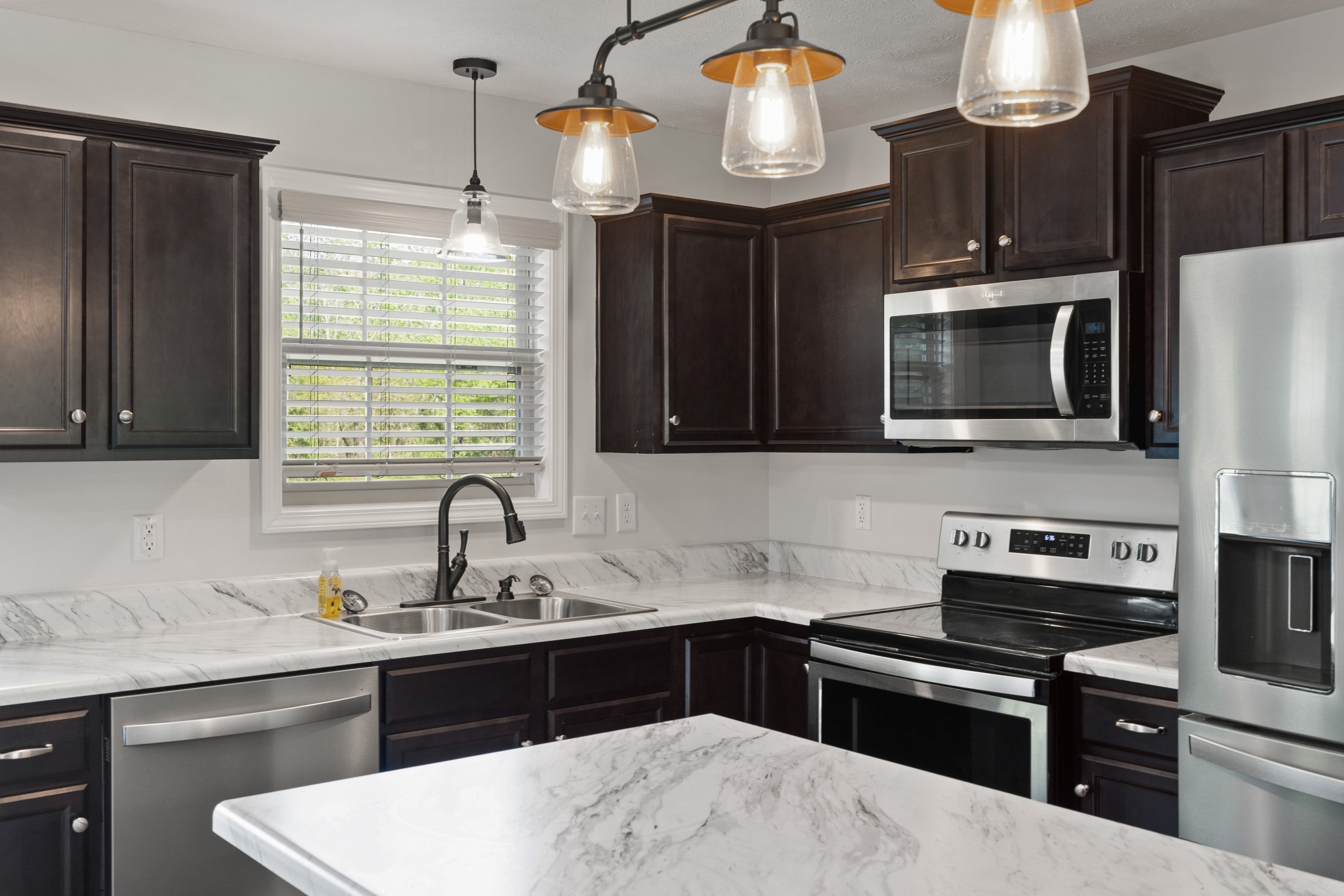1821 Rock Bridge Road Bethpage, TN 37022 - Photo 10 of 31 a kitchen with granite countertop a sink stainless steel appliances and cabinets