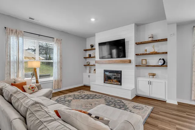 a bedroom with furniture and a fireplace