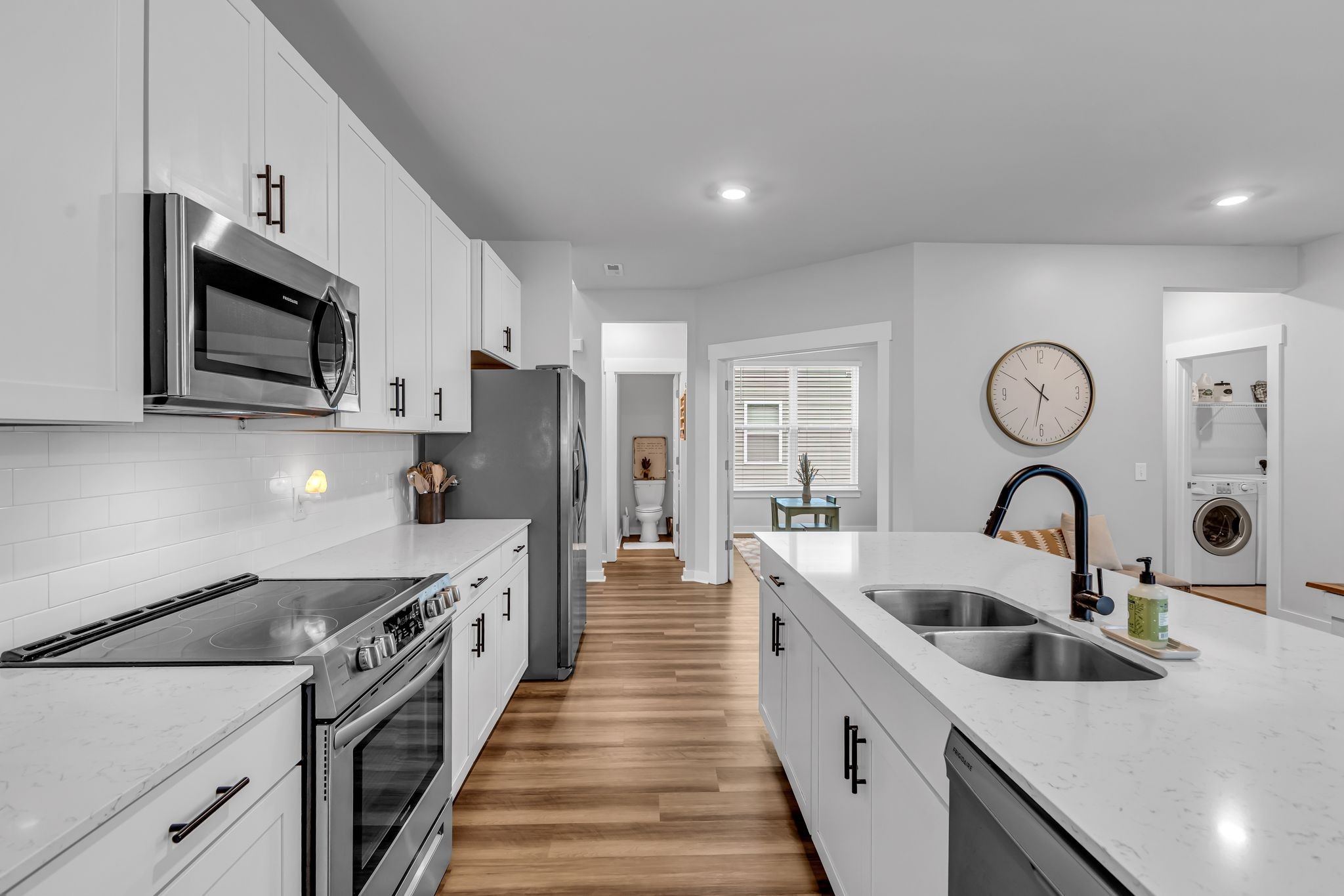 417 Irwin Way Spring Hill, TN 37174 - Photo 17 of 43 a kitchen with stainless steel appliances granite countertop a white stove top oven a sink and dishwasher