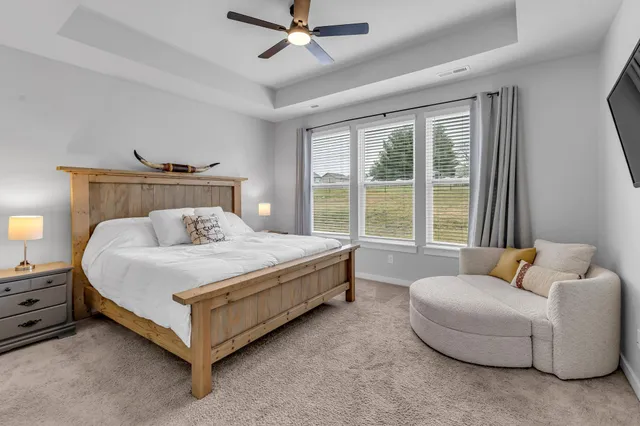 a spacious bedroom with a bed and a window