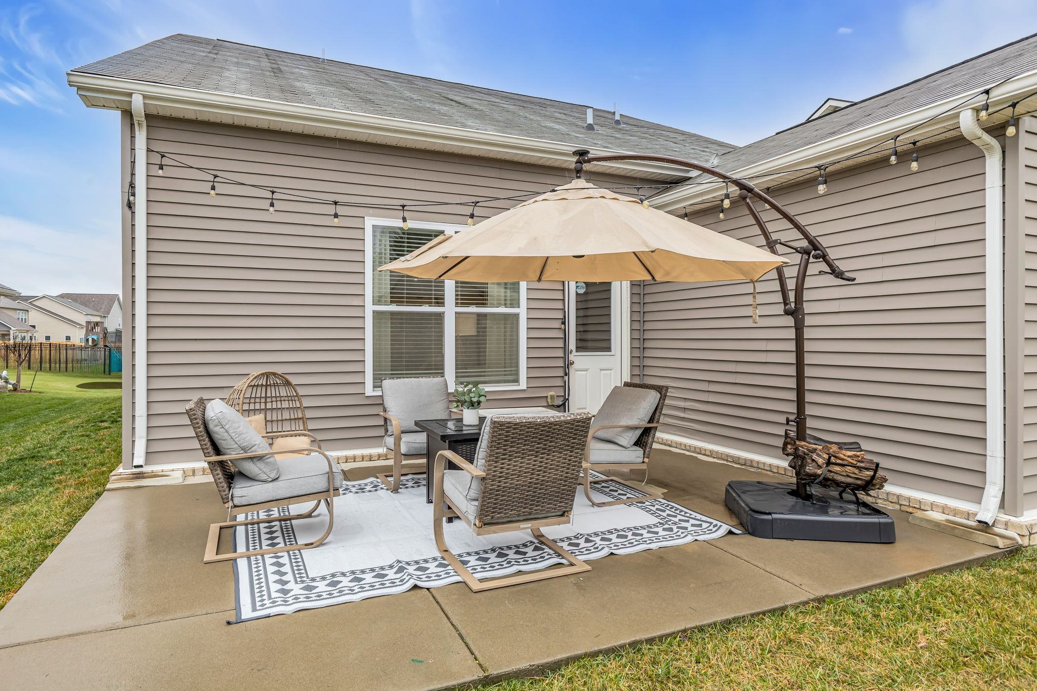 417 Irwin Way Spring Hill, TN 37174 - Photo 38 of 43 a view of a patio with table and chairs under an umbrella