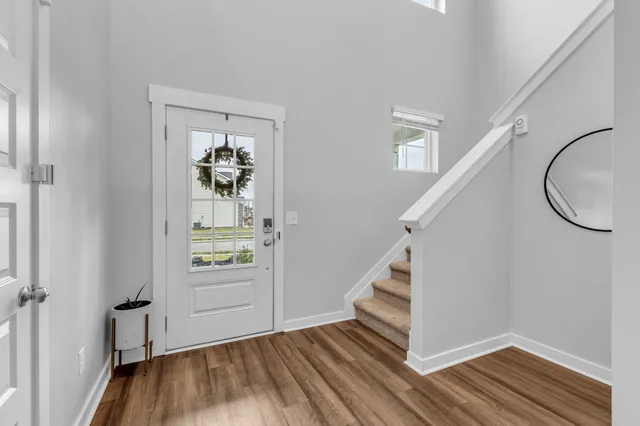 a view of an entryway with wooden floor