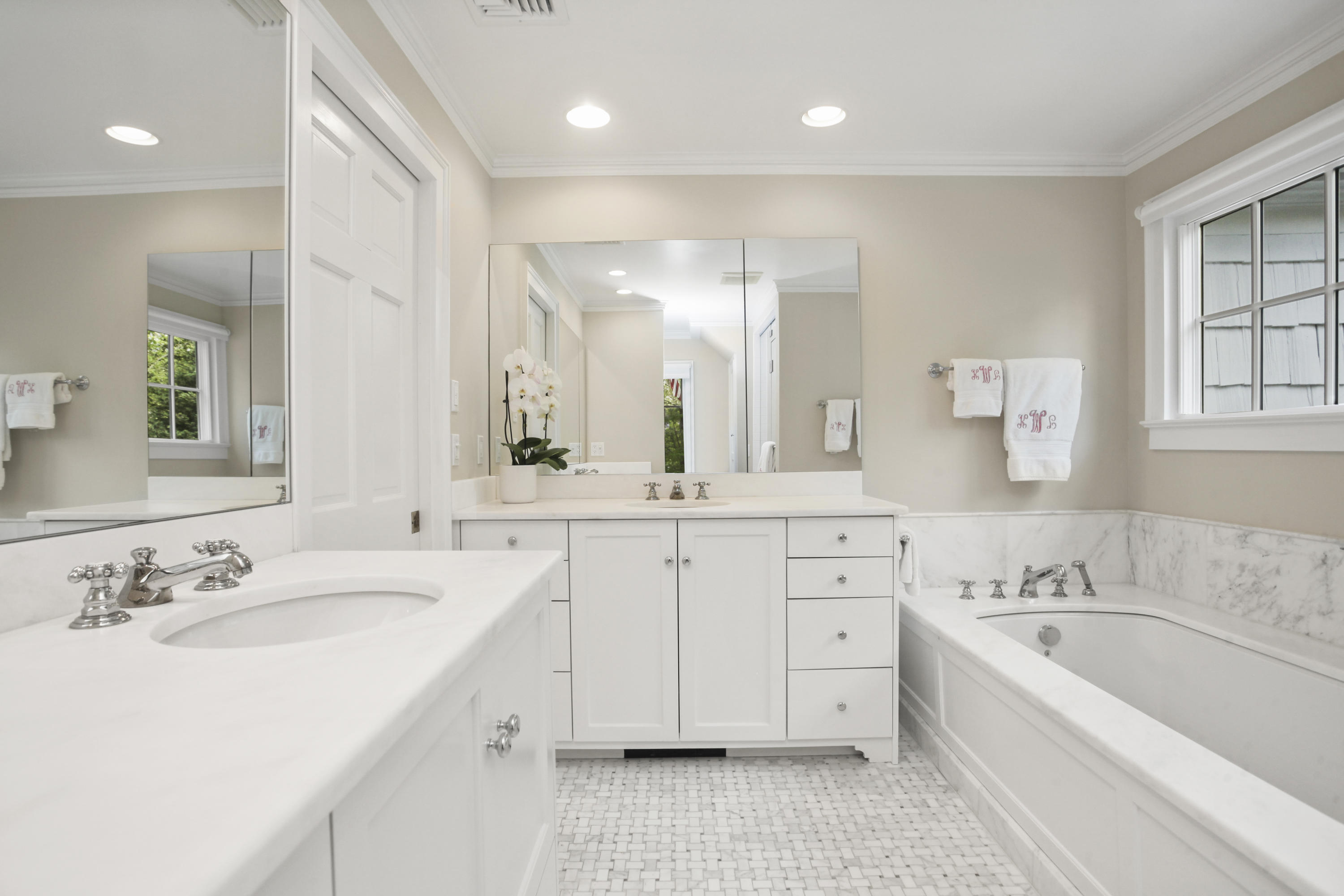 40 Birch Road Darien, CT 06820 - Photo 26 of 40 a spacious bathroom with a granite countertop sink a bathtub a mirror and a bathtub