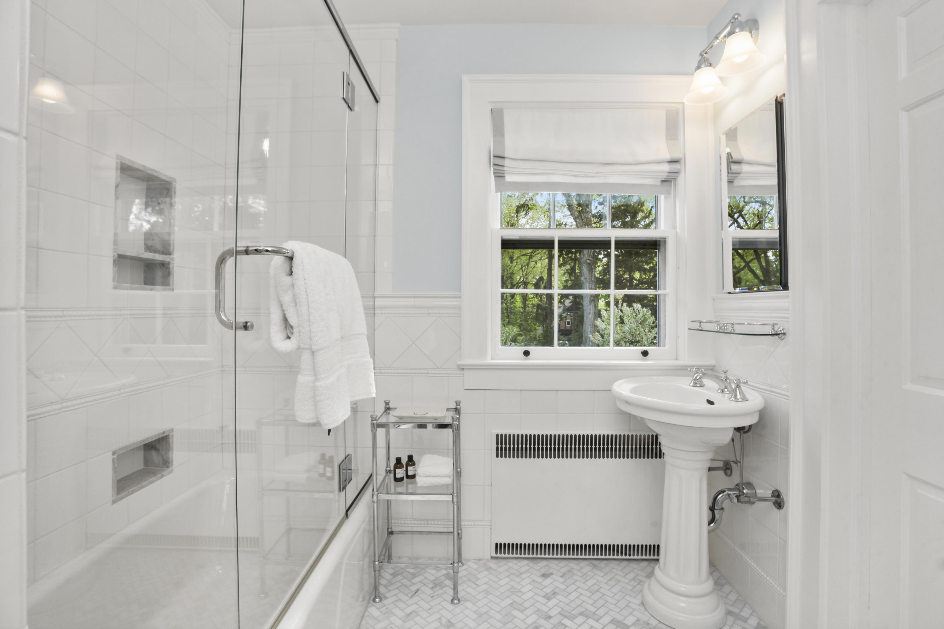 40 Birch Road Darien, CT 06820 - Photo 28 of 40 a bathroom with a sink mirror and a bathtub