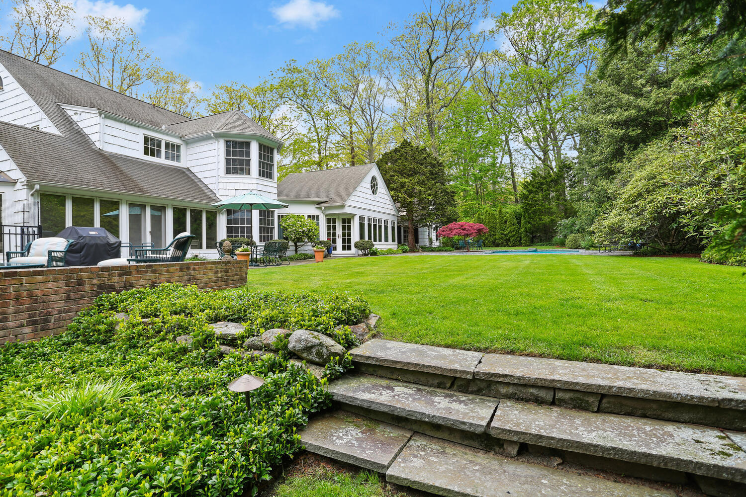40 Birch Road Darien, CT 06820 - Photo 7 of 40 a front view of a house with a yard table and chairs