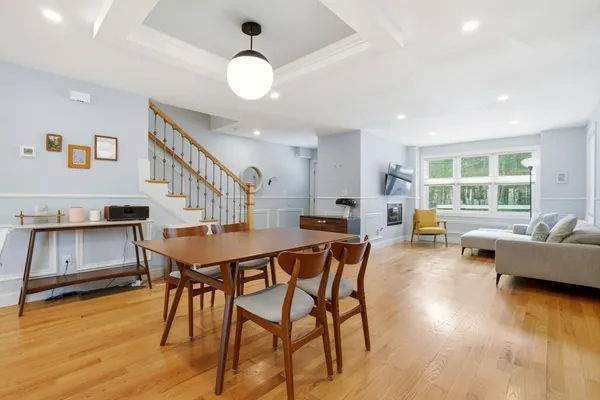 a dining room with furniture and wooden floor