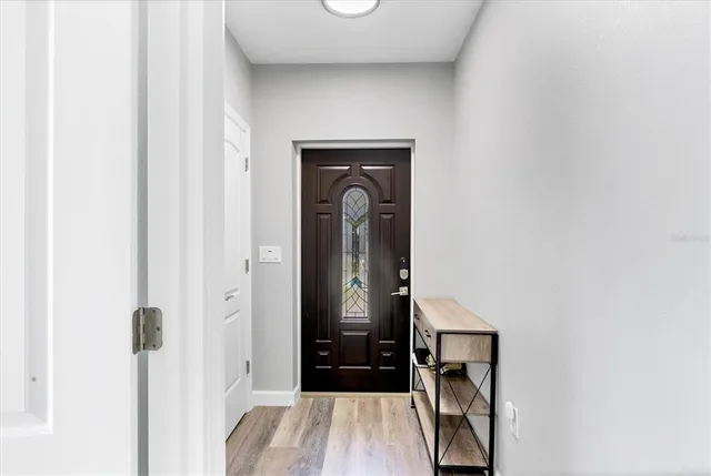 a kitchen with stainless steel appliances granite countertop a sink a stove a refrigerator cabinets and chairs