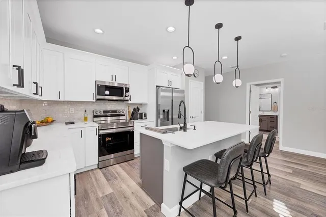 a bathroom with a sink toilet tub and shower