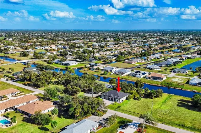 an aerial view of residential houses with yard and lake view