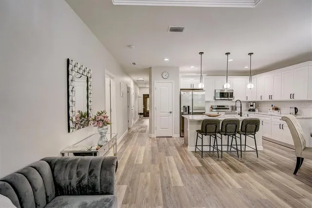 a living room with furniture and a potted plant