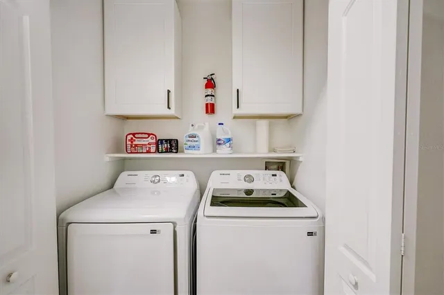 a view of a house with backyard sitting area and lake view