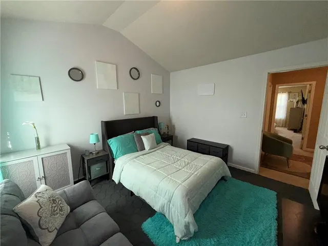 a bedroom with a bed and a mirror