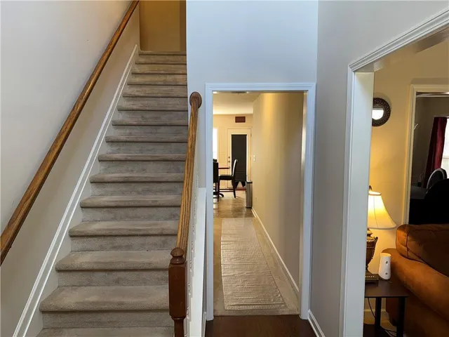 a view of a hallway with wooden floor and entryway