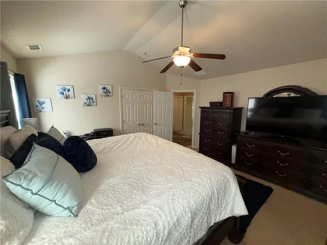 a bedroom with a bed and a television