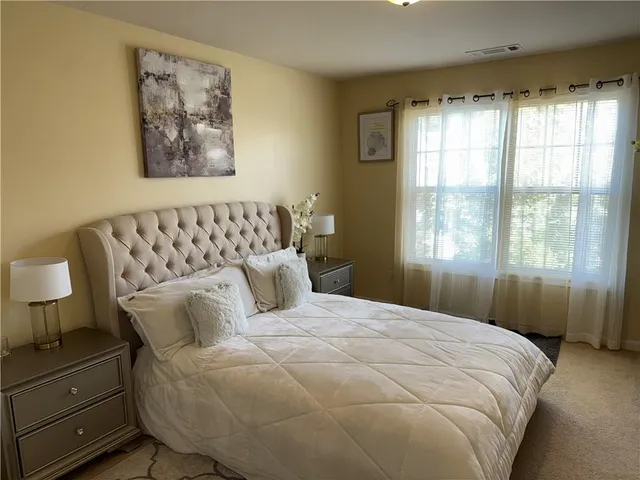 a bedroom with a bed and window