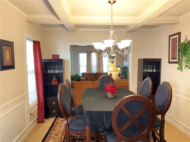 a view of a dining room with furniture and chandelier