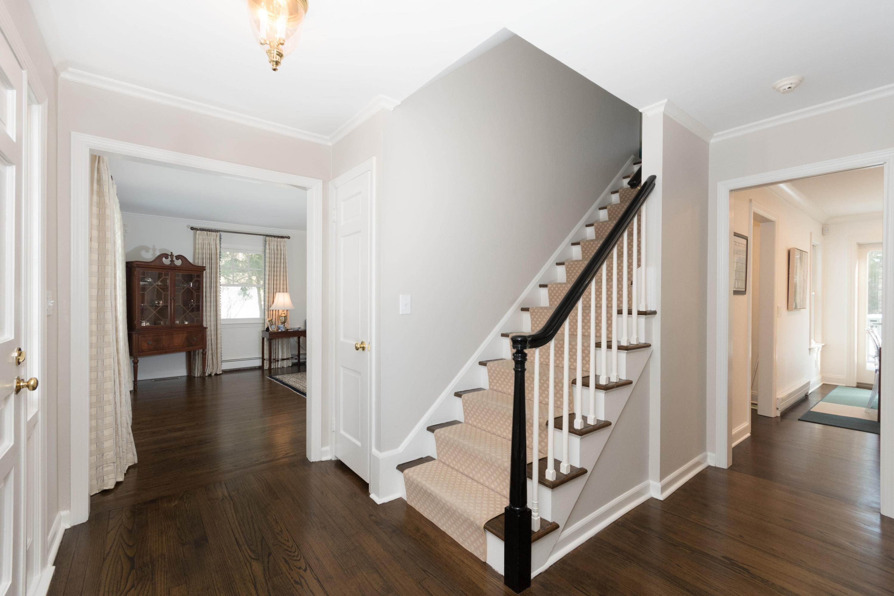 17 Country Club Road Darien, CT 06820 - Photo 3 of 37 a view of a hallway with wooden floor and staircase