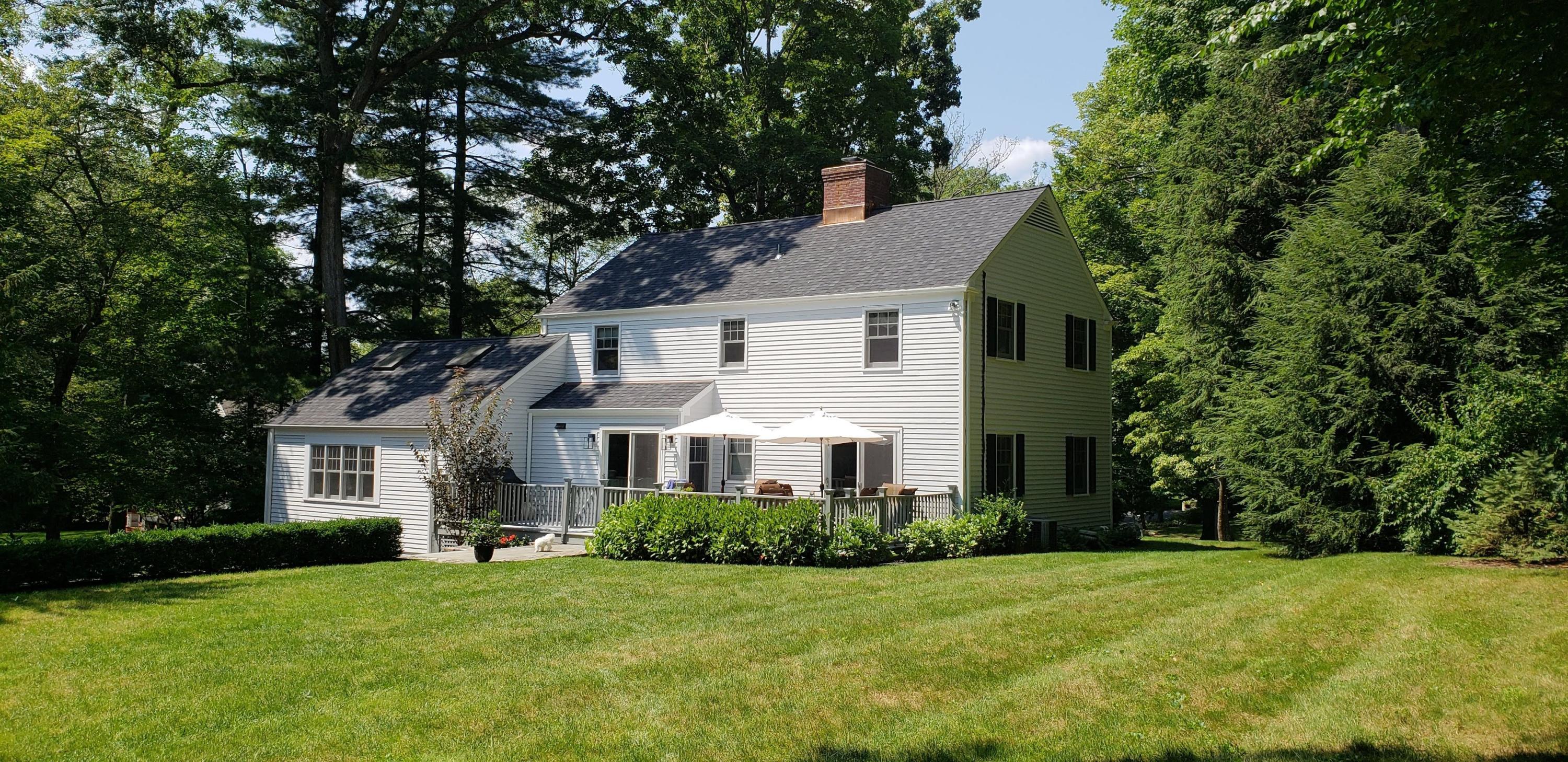 17 Country Club Road Darien, CT 06820 - Photo 32 of 37 a front view of a house with a yard and trees
