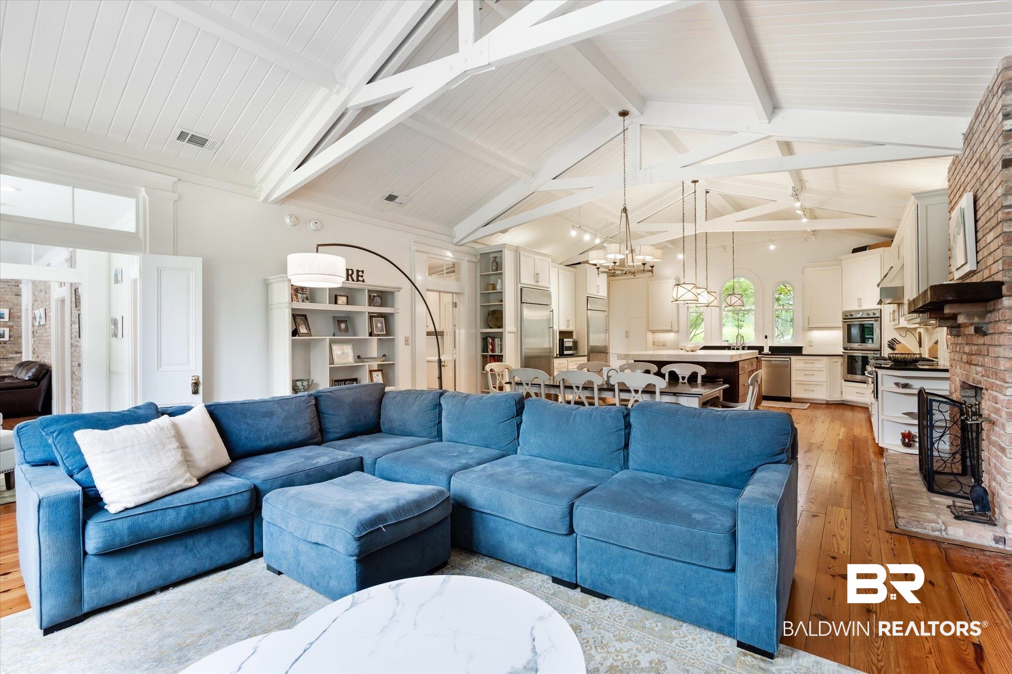 2205 Spring Hill Avenue Mobile, AL 36607 - Photo 16 of 59 Living room with ceiling fan with notable chandelier, high vaulted ceiling, light wood-type flooring, sink, and beam ceiling