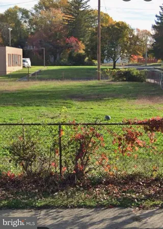 a view of a park with swings and trees