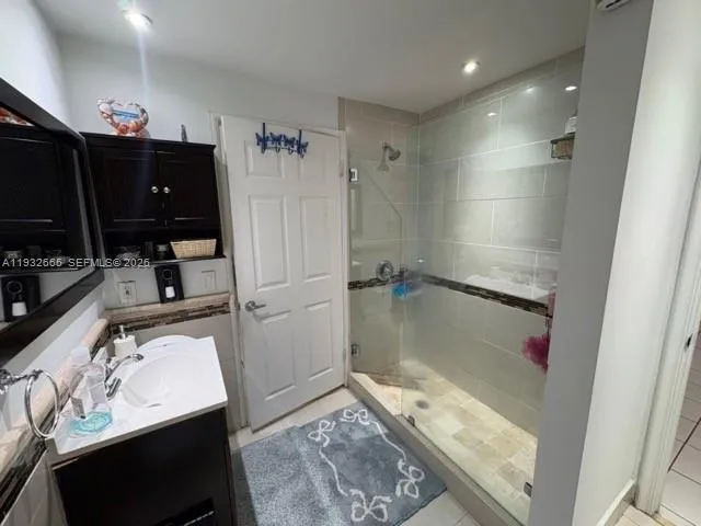 a bathroom with a sink vanity and a mirror