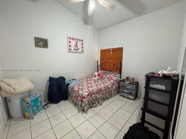 13521 Southwest 62nd Street, Unit 119 Miami, FL 33183 - Photo 13 of 19 a bedroom with a bed and a lamp on table