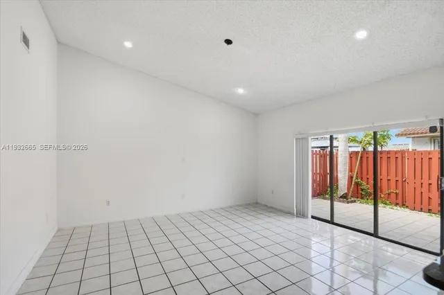 a walk in closet with wooden floor