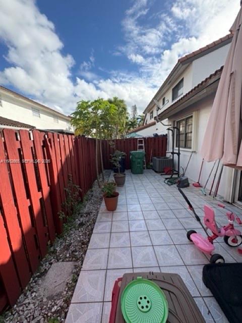 13521 Southwest 62nd Street, Unit 119 Miami, FL 33183 - Photo 17 of 19 a view of a backyard with potted plants and wooden fence