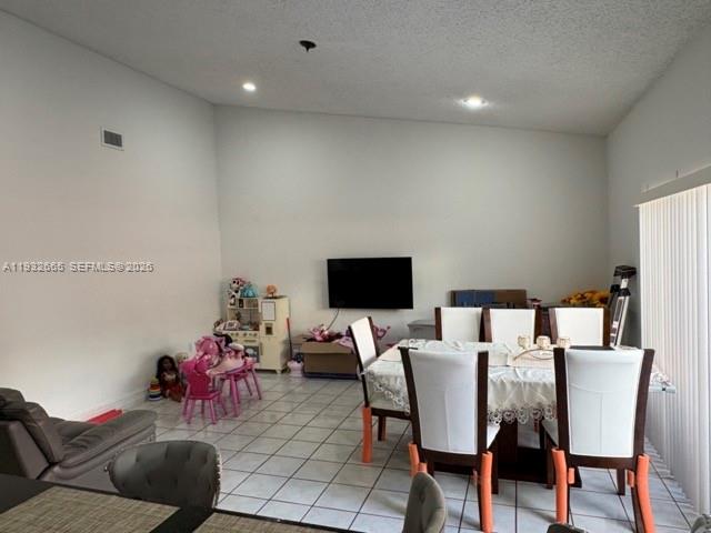 13521 Southwest 62nd Street, Unit 119 Miami, FL 33183 - Photo 18 of 19 a living room with furniture and a flat screen tv