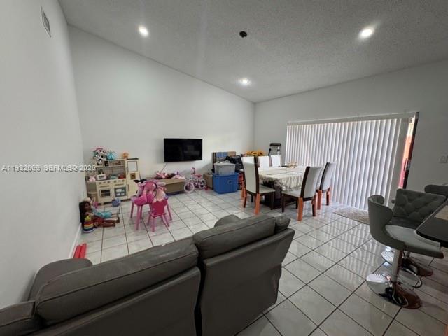 13521 Southwest 62nd Street, Unit 119 Miami, FL 33183 - Photo 3 of 19 a living room with furniture and a flat screen tv