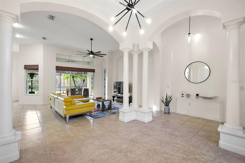 9930 Santa Barbara Court Howey-in-the-Hills, FL 34737 - Photo 11 of 44 a living room with furniture and a chandelier